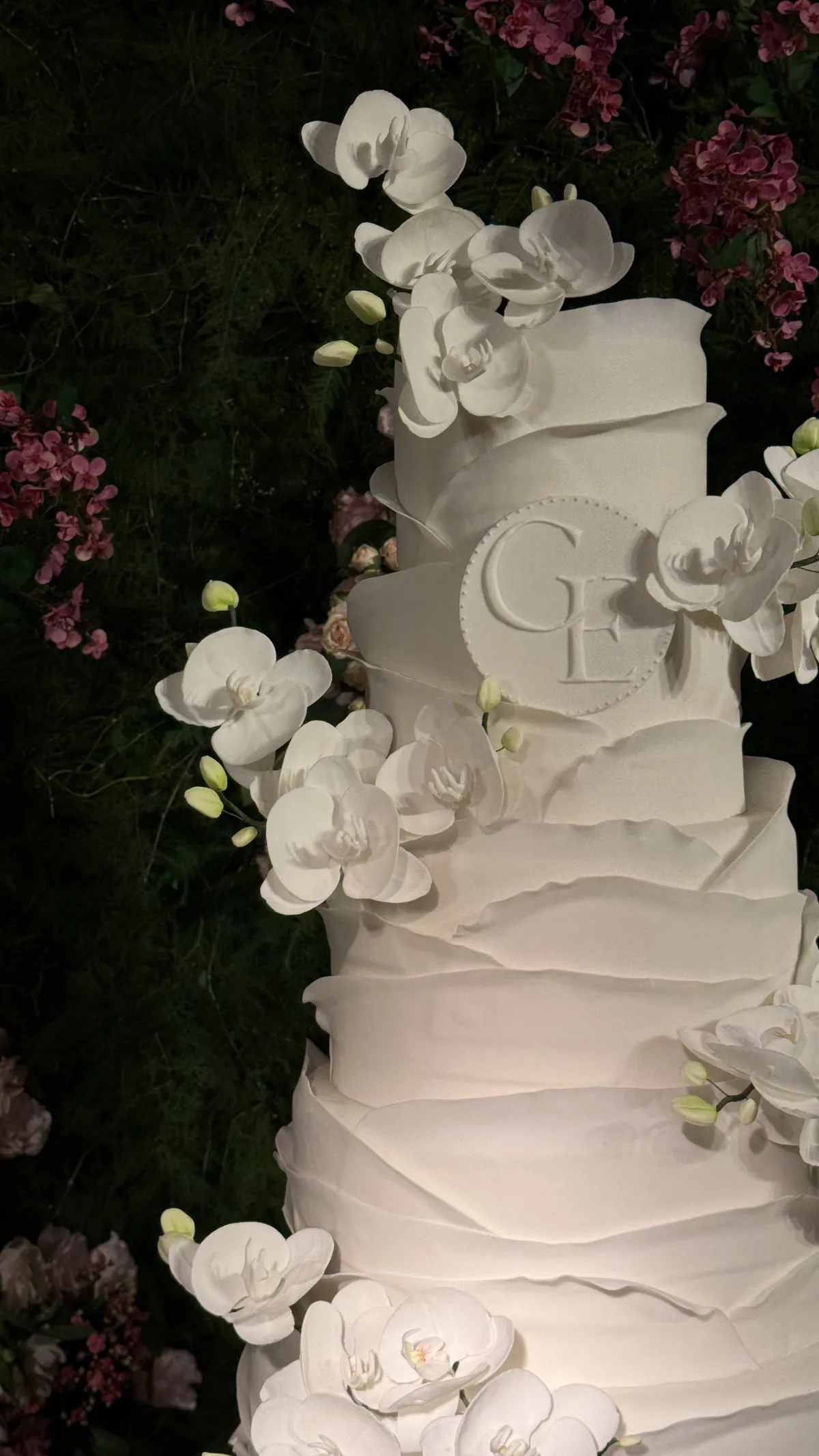 Bolo branco alto com orquídeas de açúcar e monograma